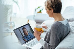 Woman using laptop and having video call with her mediator
