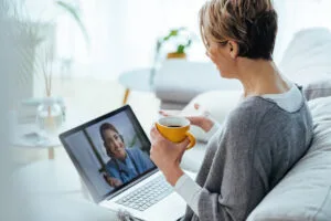Woman using laptop and having video call with her mediator